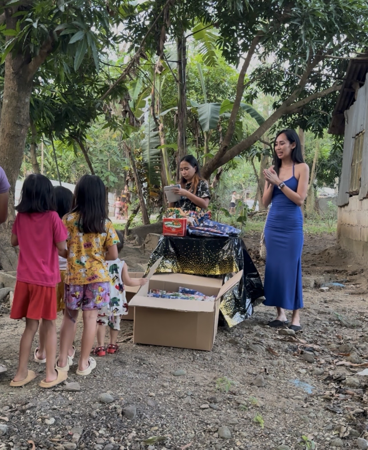 Ember children receiving gifts from Mary Joy C. Olmstead