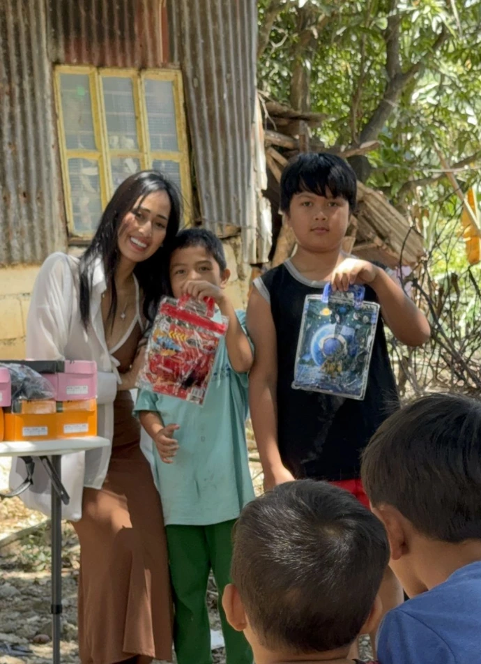 Children receiving shoes from Ember Program representative Mary Joy Olmstead