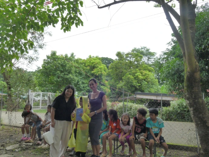 Children receiving raincoats for the rainy season