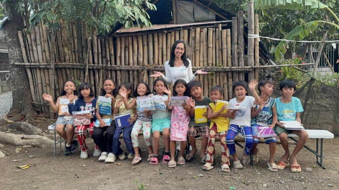 Children show off their new school supplies from the Ember Program